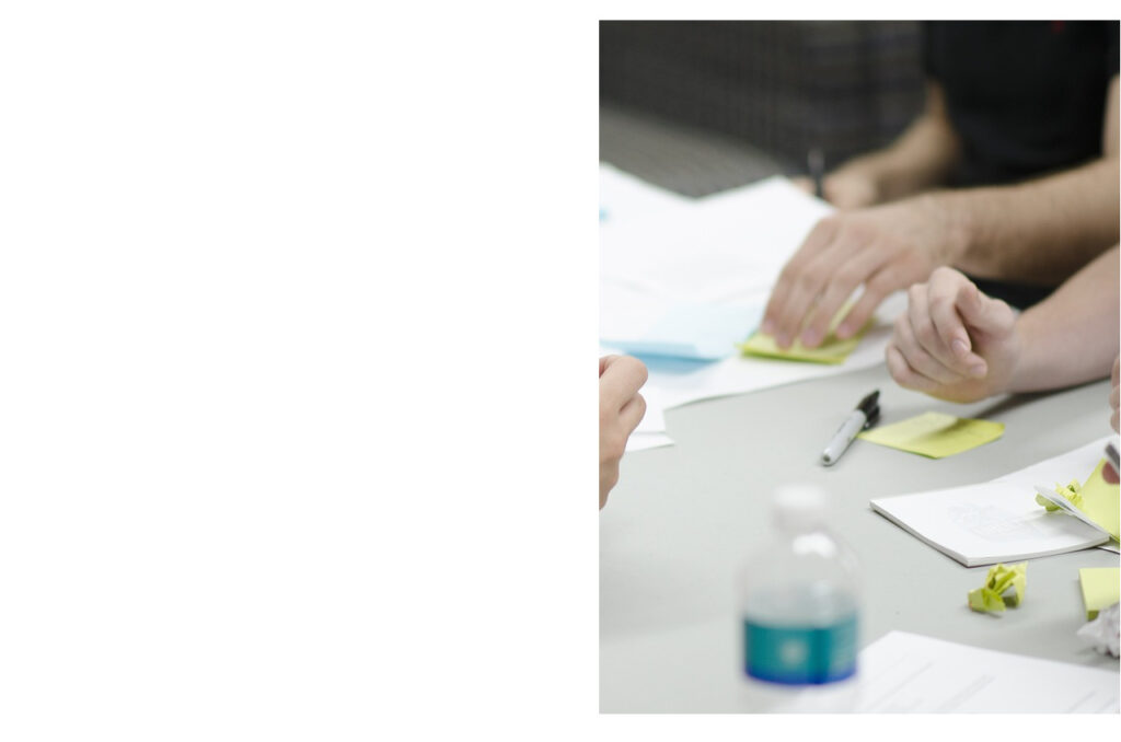 A picture with hands of people sitting at the table and making notes