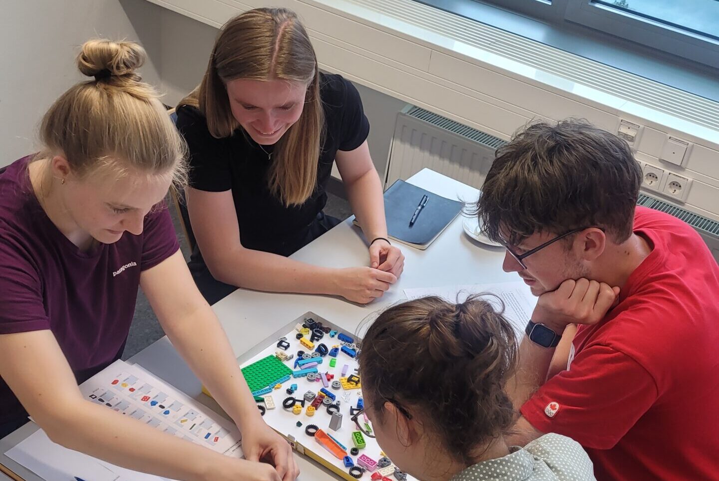 A group of doctoral researchers (two women and two men) during the course