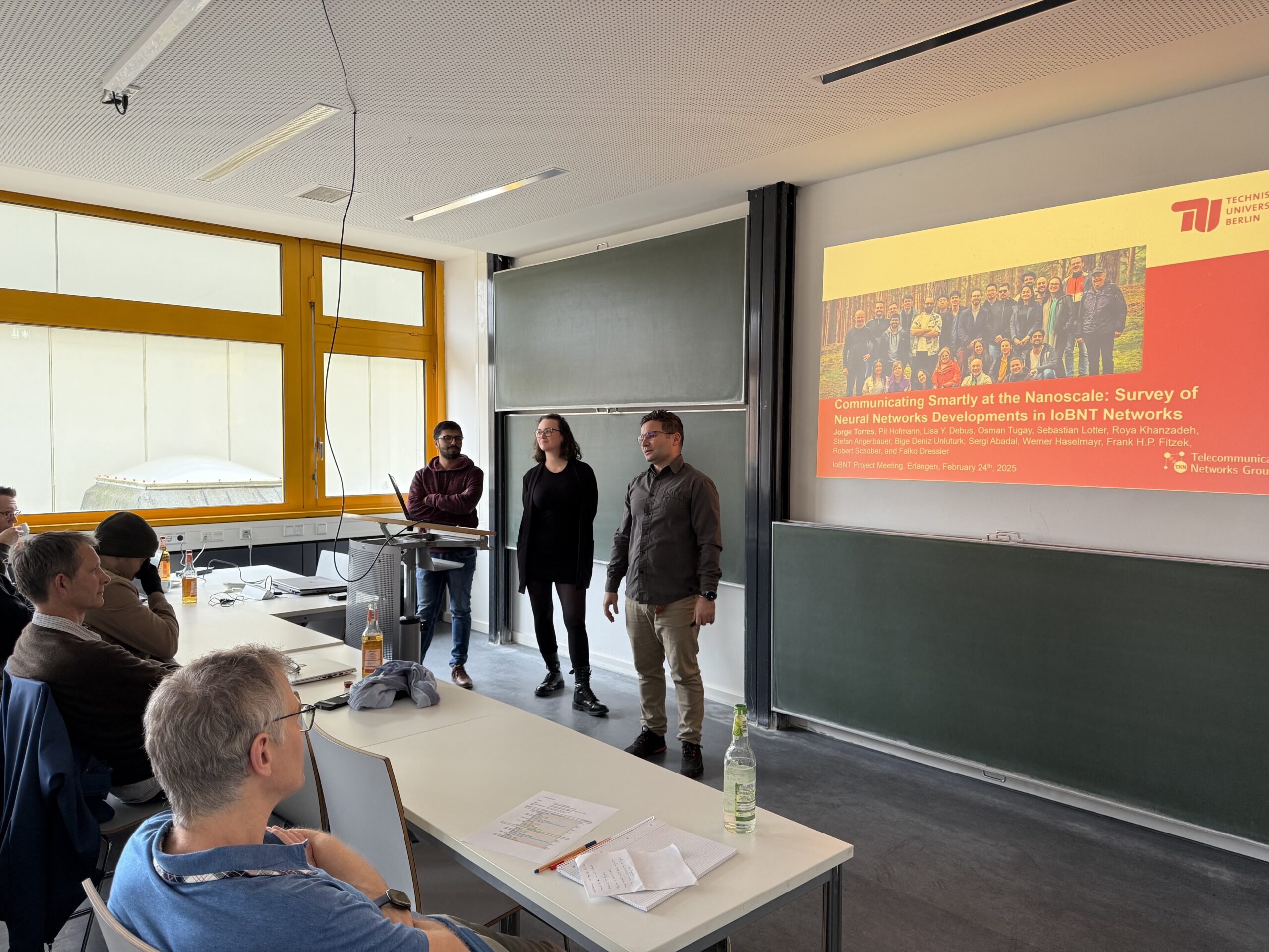 Three people during the presentation at the project meeting