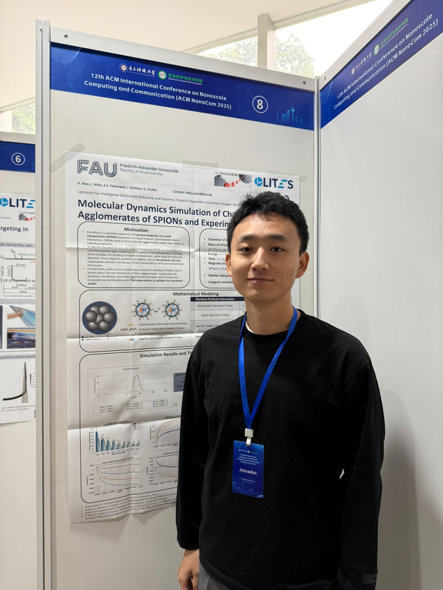 Keyu (male) with his poster at the NanoCom