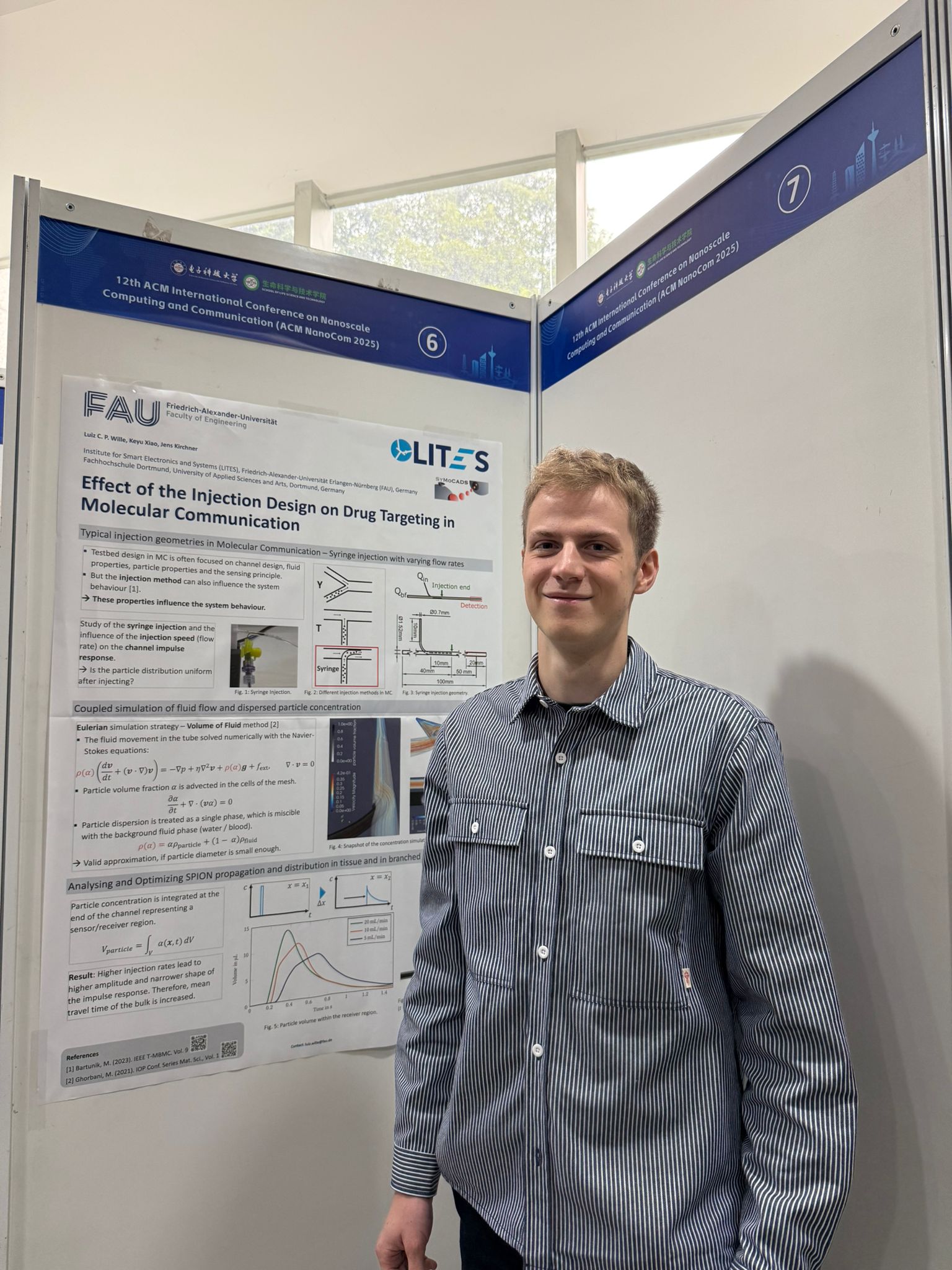 Luiz (male) with his poster at the NanoCom