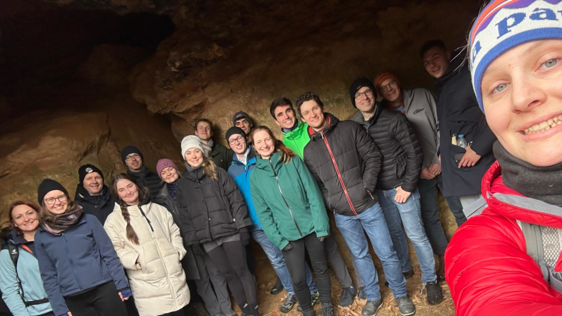SyMoCADS hike - a group of people male and female in a cave during the hike 