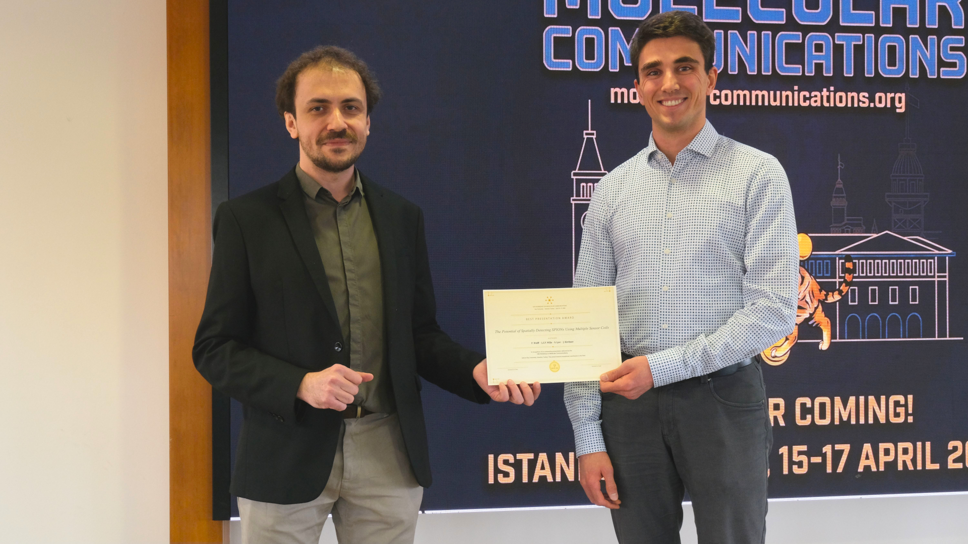 Paul Wolff (male) receiving the Best Presentation Award