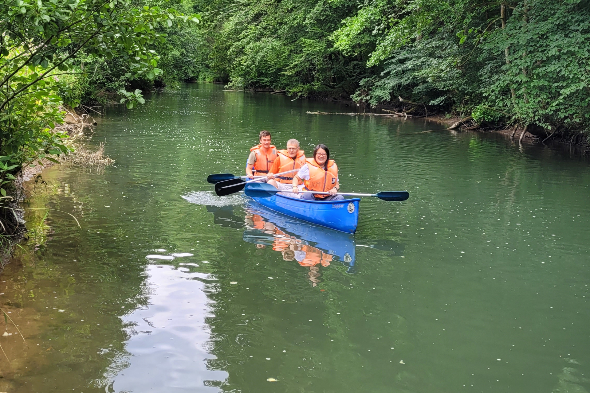 Two males and a female in a canoe