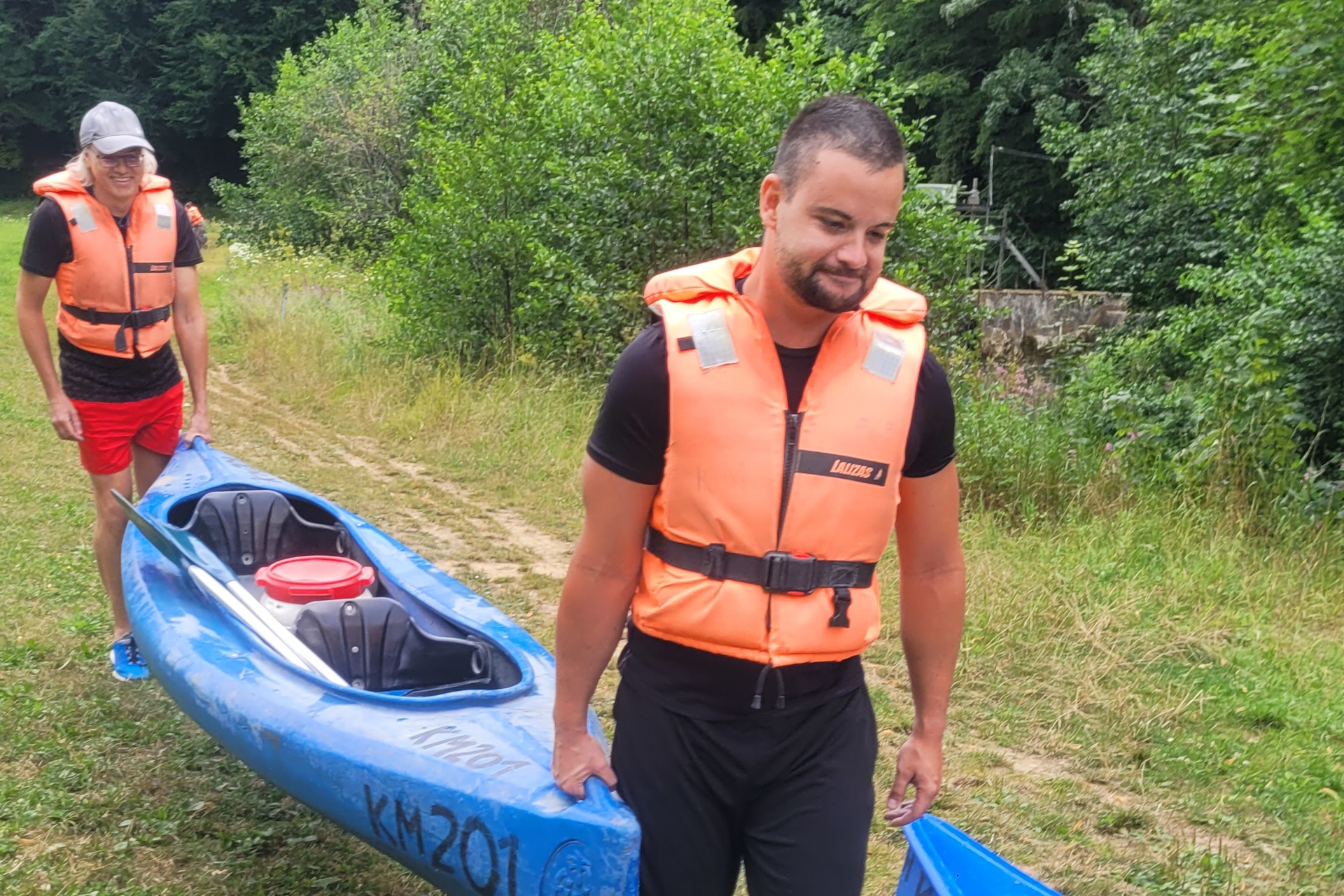 Two males carrying a kayak